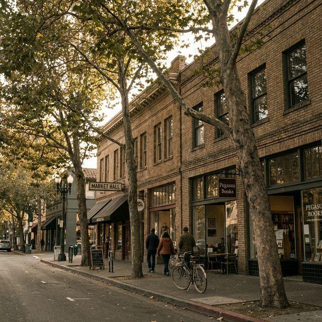 College Avenue in Rockridge, Oakland at dusk with tree-lined sidewalks and independent storefronts